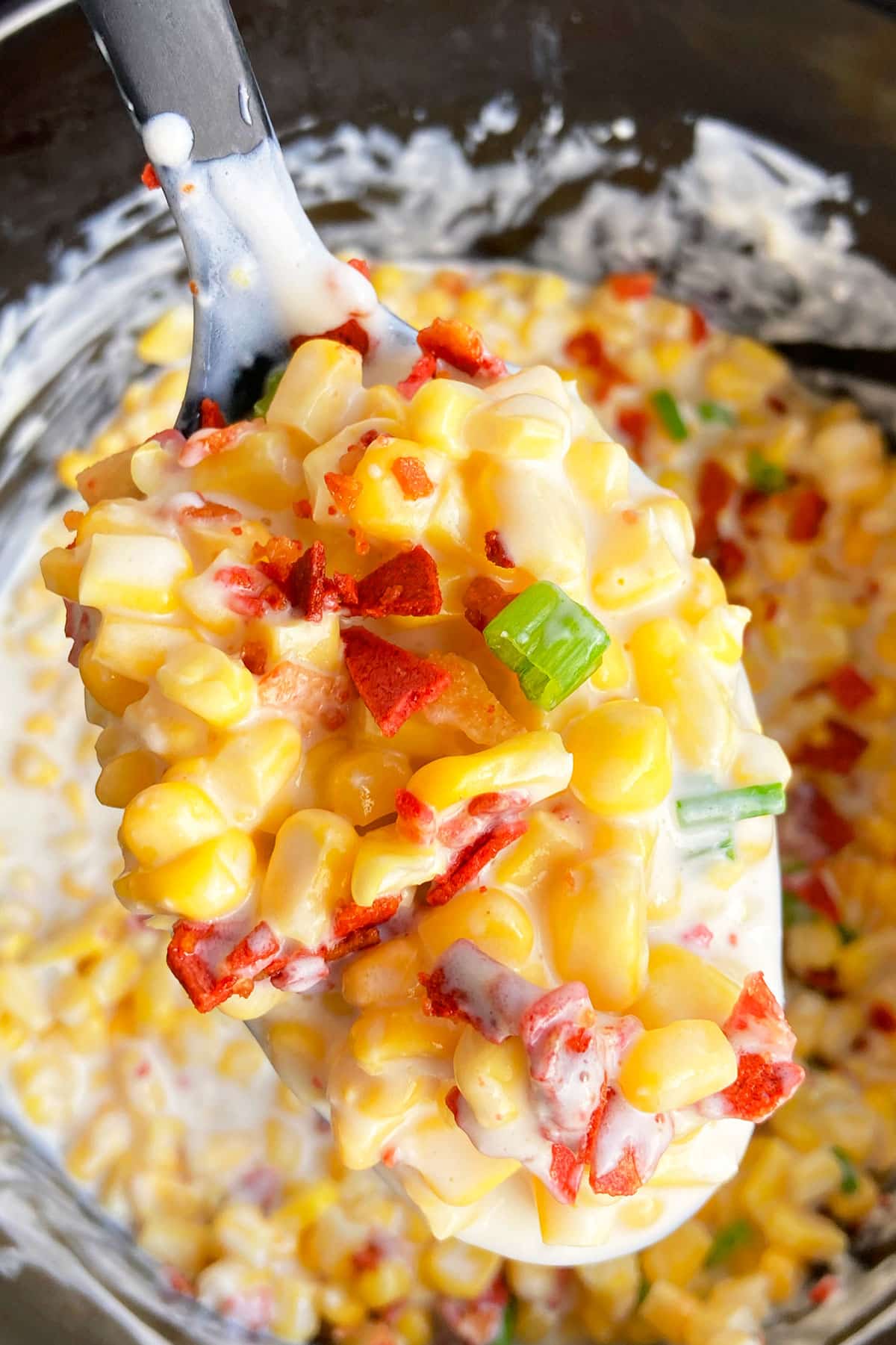 Spoonful of Homemade Cheesy Corn- Closeup Shot.