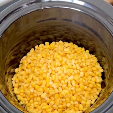 Frozen corn in black pot. 