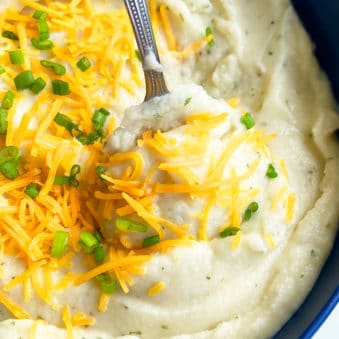 Spoonful of Slow Cooker Mashed Potatoes in Blue Bowl