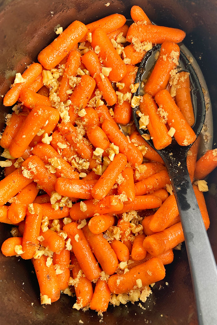 Easy Glazed Carrots With Brown Sugar and Nuts in Black Crockpot- Overhead Shot