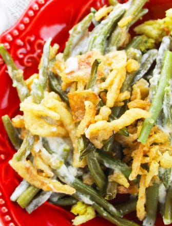 Easy Crockpot Thanksgiving Green Bean Casserole Served in Red Dish