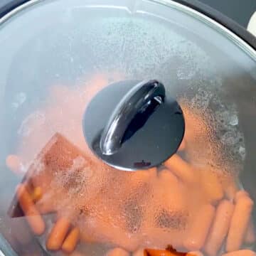 Crockpot with lid covered and steam forming.