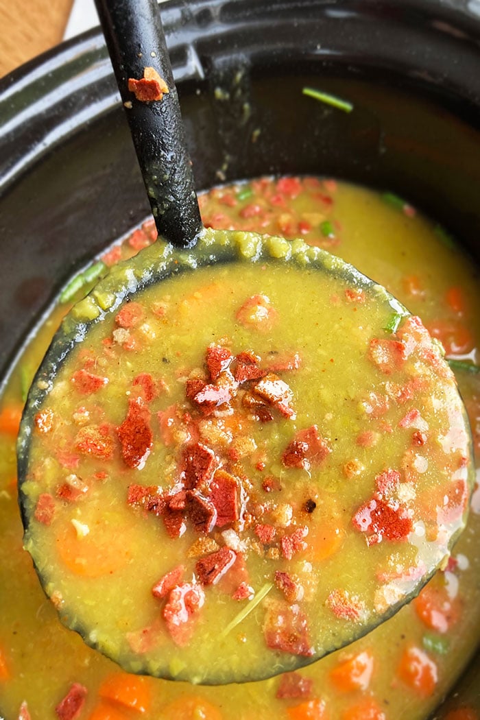 Closeup Shot of Spoonful of Best Green Pea Soup Topped off with Bacon Bits