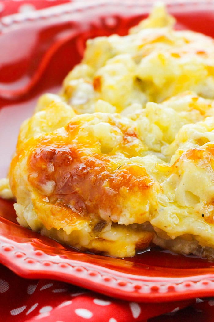 Cheesy Hashbrown Casserole in Red Plate- Closeup Shot