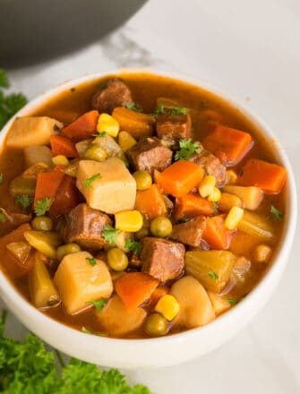 Slow Cooker Beef Stew Served in White Bowl on Marble Background