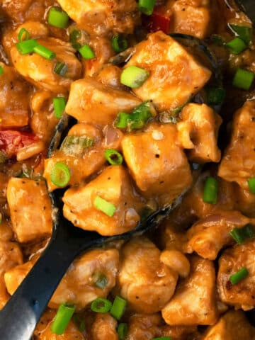 Black Spoon Full of Slow Cooker Thai Peanut Chicken- Overhead Shot.