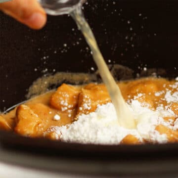 Cornstarch slurry being added to slow cooker. 