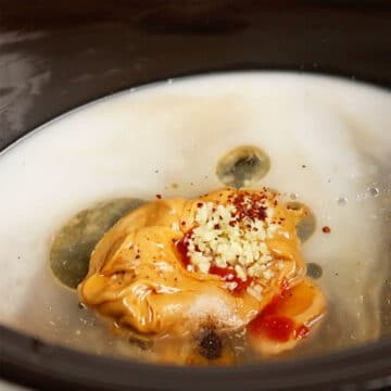 Slow cooker with Thai sauce ingredients. 