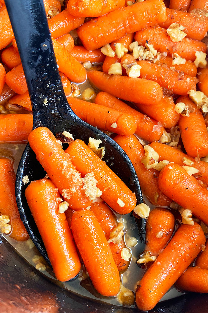 Easy Orange Candied Carrots With Honey in Black Slow Cooker 