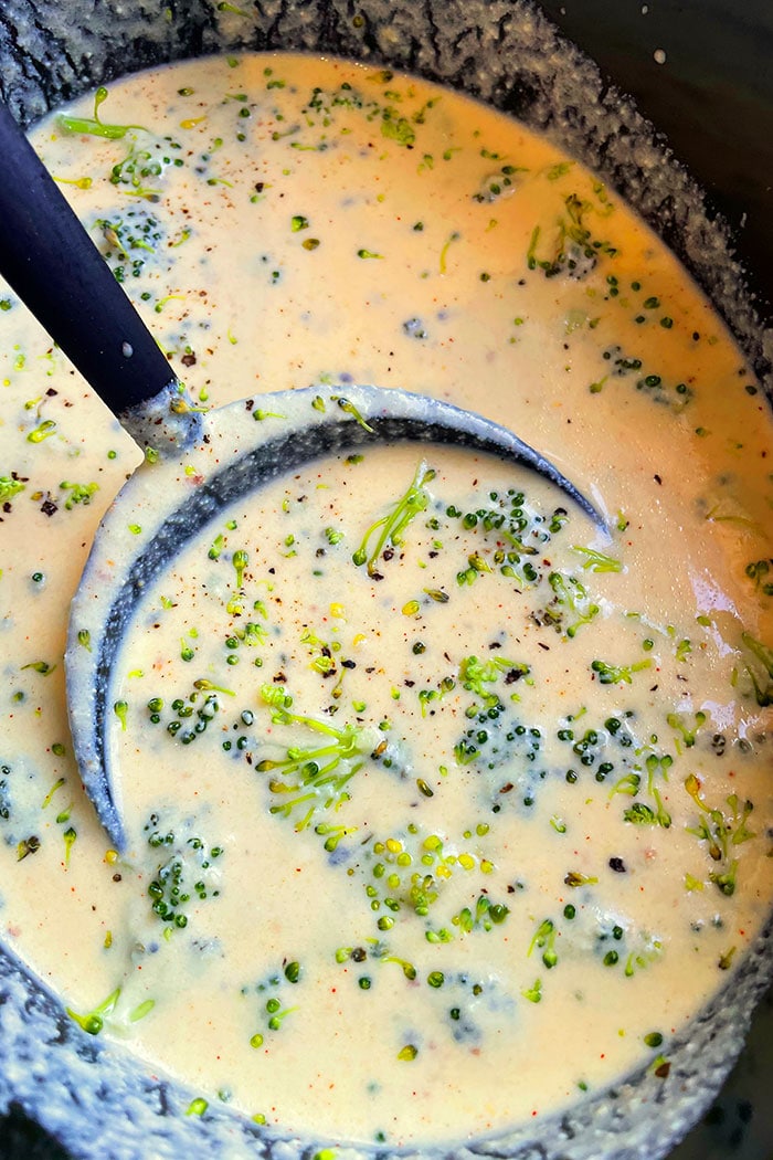 Creamy Homemade Broccoli Cheese Soup in Black Crockpot 
