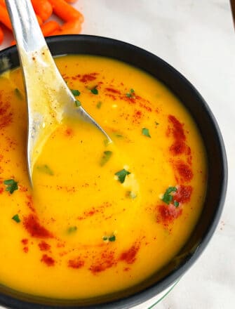 Easy Creamy Slow Cooker Carrot Soup Served in Black Bowl
