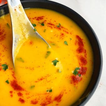 Easy Creamy Slow Cooker Carrot Soup Served in Black Bowl
