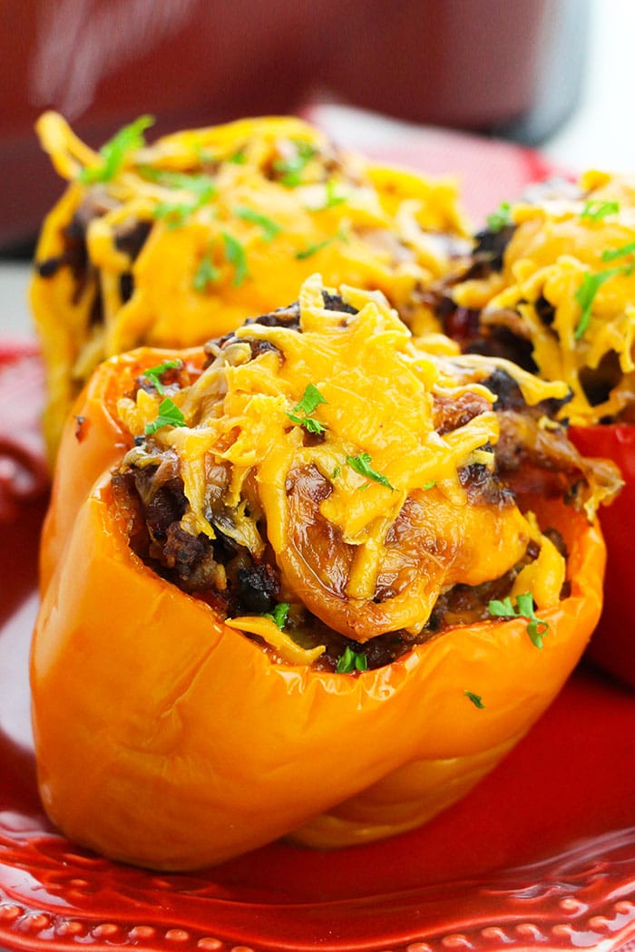 Slow Cooker Stuffed Bell Peppers With Rice, Cheese and Ground Beef,  Served in Red Plate