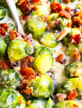 Closeup Shot of Spoonful of Easy Slow Cooker Garlic Parmesan Creamy Brussels Sprouts With Bacon