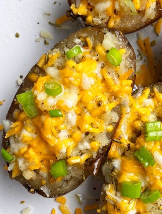 Easy Cheesy Slow Cooker Twice Baked Potatoes Served in White Plate- Overhead Shot