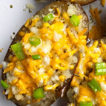Easy Cheesy Slow Cooker Twice Baked Potatoes Served in White Plate- Overhead Shot