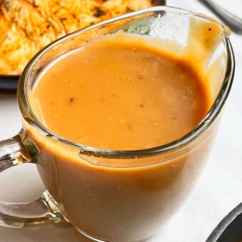 Easy Homemade Slow Cooker Brown Turkey Gravy From Drippings in Glass Cup