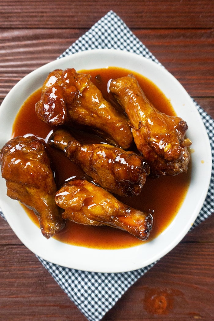 Slow Cooker Honey BBQ Wings in White Dish on Wood Table Background
