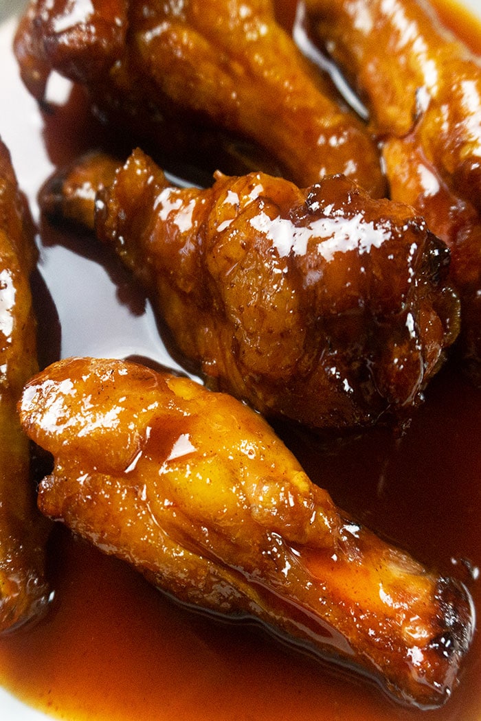 Tender Barbecue Chicken Wings in White Dish- Closeup Shot