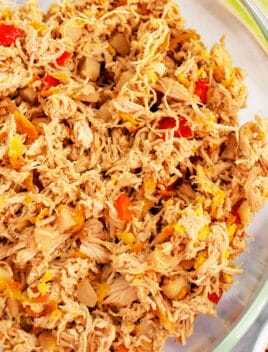 Easy Slow Cooker Shredded Asian Chicken Served in a Glass Bowl