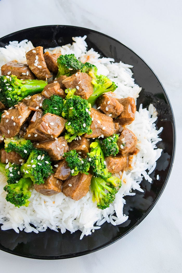 Homemade Beef Broccoli Over Steamed Rice in Black Plate 