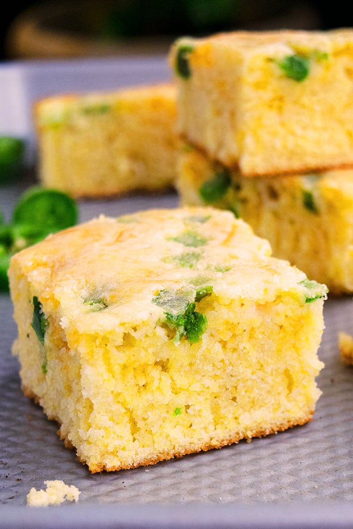 Slice of Slow Cooker Mexican Jalapeno Cornbread With Jiffy Corn Mix on Silver Tray