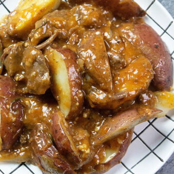 Slow Cooker Beef Tips and Gravy Served in White and Black Checkered Plate