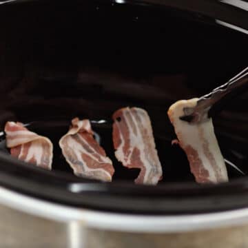 Bacon strips being added to slow cooker.