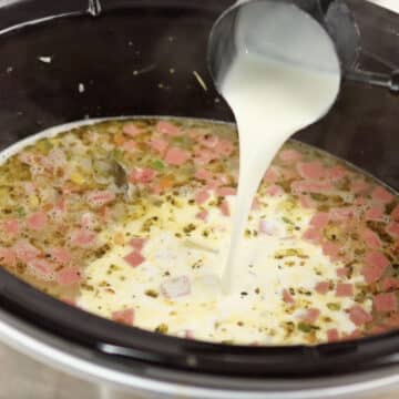 Half and half being poured into slow cooker. 