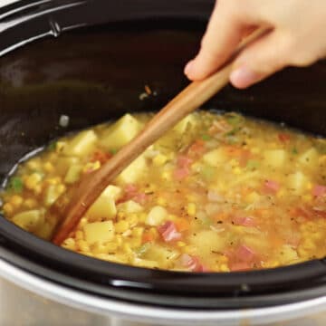 Mixing ingredients in black crockpot. 