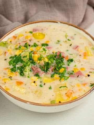 Bowl of Slow Cooker Corn Chowder With Fresh Parsley Garnish.