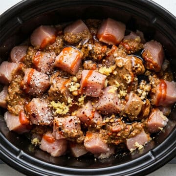 Ingredients in black slow cooker.