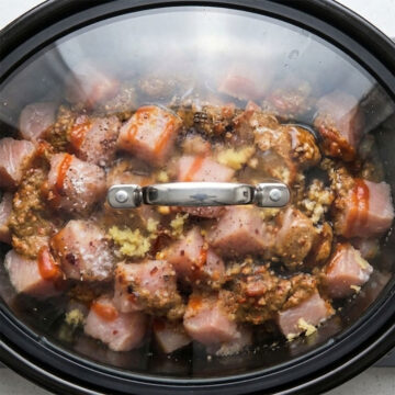 Ingredients cooking in covered slow cooker.