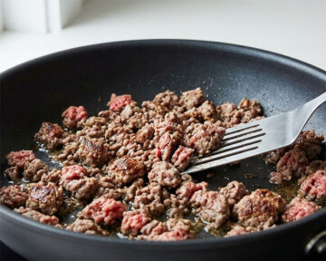 Browning ground beef in nonstick pan. 