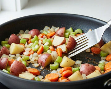 Sautéing vegetables in nonstick pan. 
