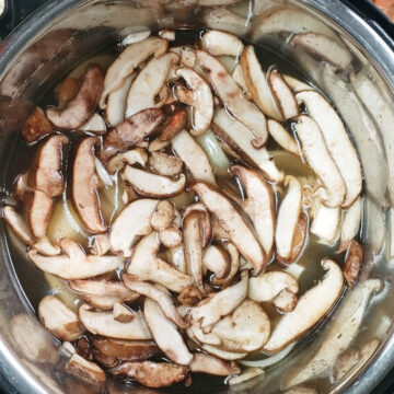 Broth and mushrooms added to pot. 